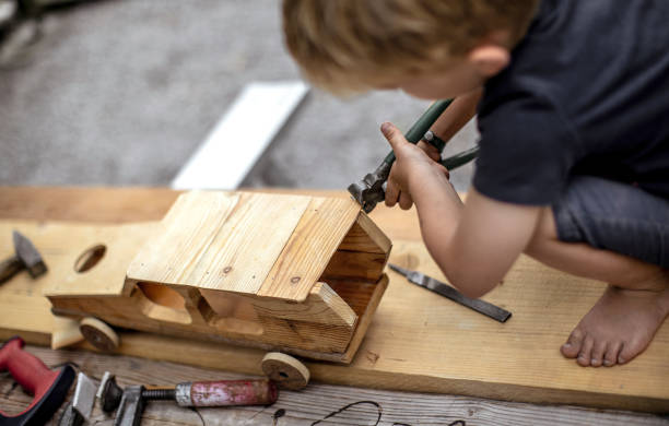 istock Young Child Crafting a Car From Wood 1168191016
