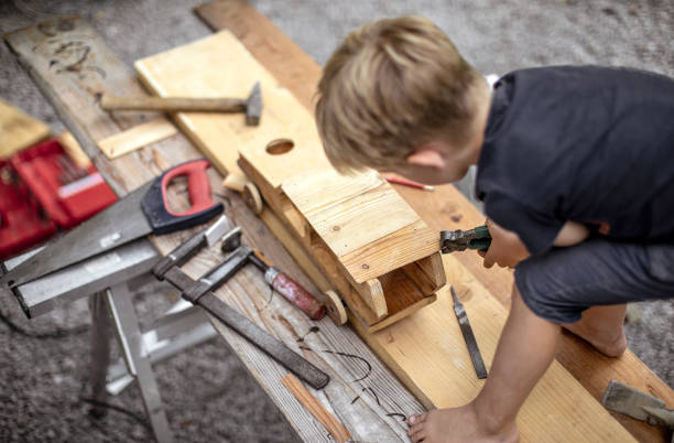 istock Young Child Crafting a Car From Wood 1168191196