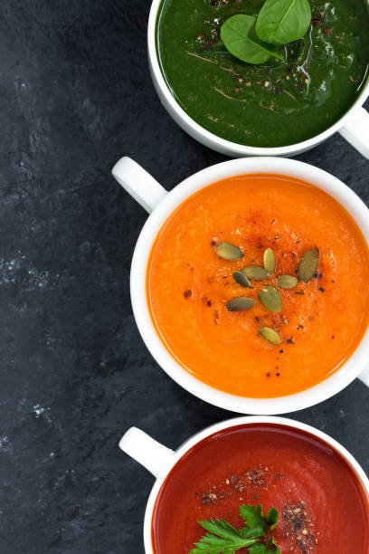 istock assortment of fresh vegetable soup on a dark background, closeup, top view, vertical 1168191612