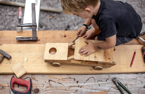 istock Young Child Crafting a Car From Wood 1168191627