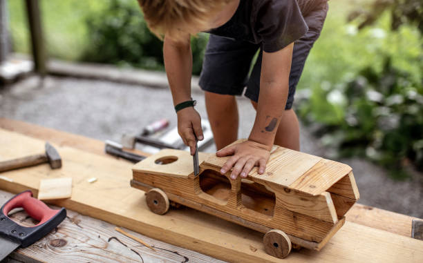 istock Young Child Crafting a Car From Wood 1168193518