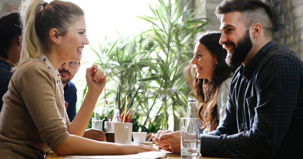 istock Happy colleagues from work socializing in restaurant 1168194938