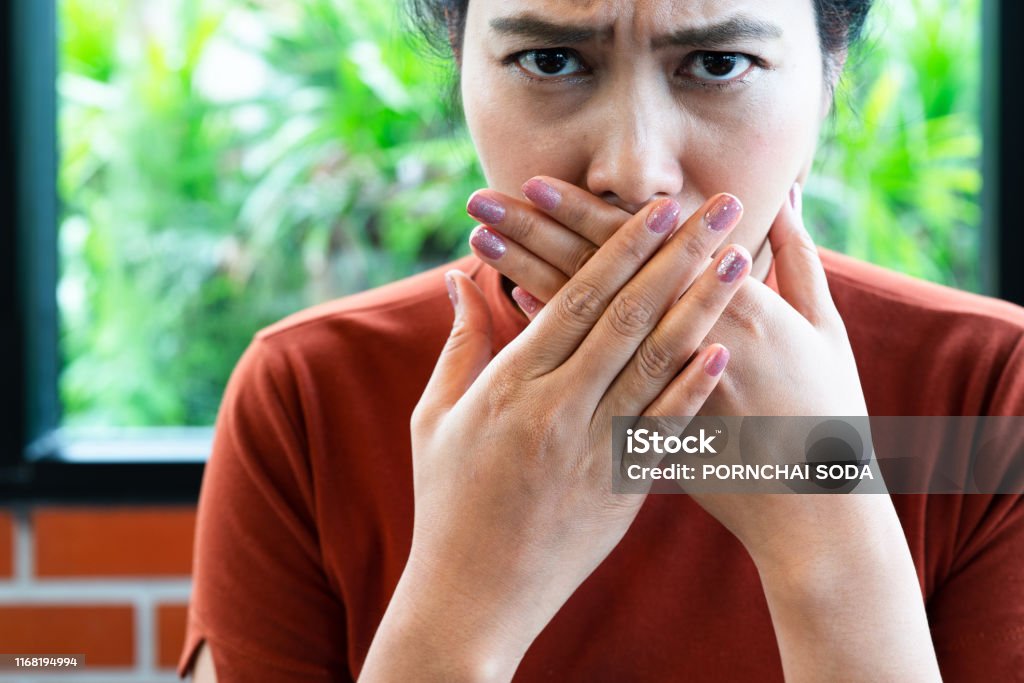 Woman with bad breath covering mouth, halitosis concept Bad Breath Stock Photo