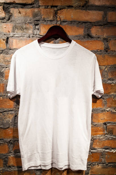 istock White blank t-shirt hanging on a red brick wall 1168196472