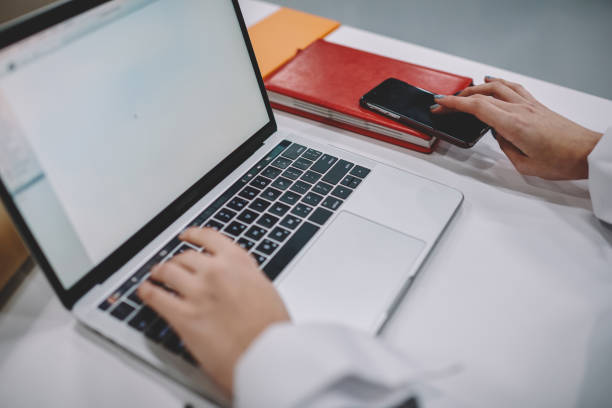 istock Selective focus on female student hands keyboarding information on laptop computer connected to wifi during preparation to exams, cropped image of woman making presentation on netbook sitting at table 1168197091