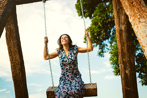Woman in the swing in a public park