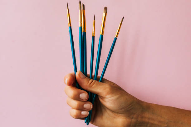 istock paint brushes on the pink background 1168204454