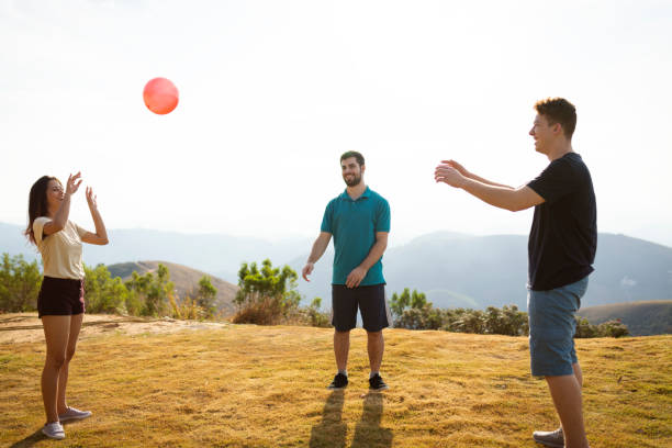 istock Three teenagers playing ball outdoors on the grass 1168206359