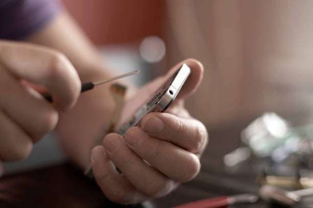 istock Male Engineer Repairs Smart Phone 1168206802