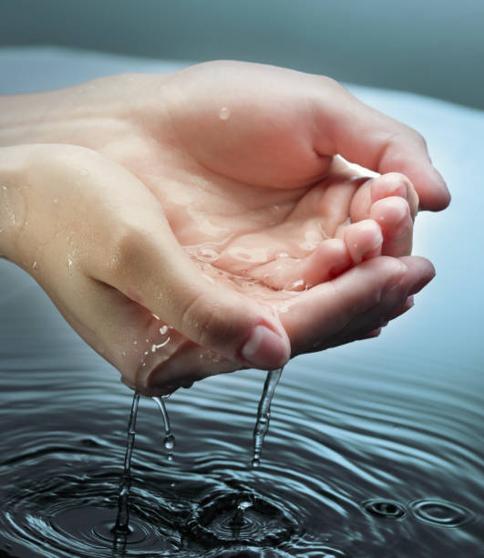 istock woman hands in blue water 1168210038