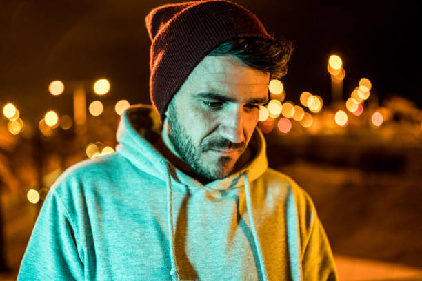 istock Frustrated man wearing casual clothes and a wool hat at night 1168216279