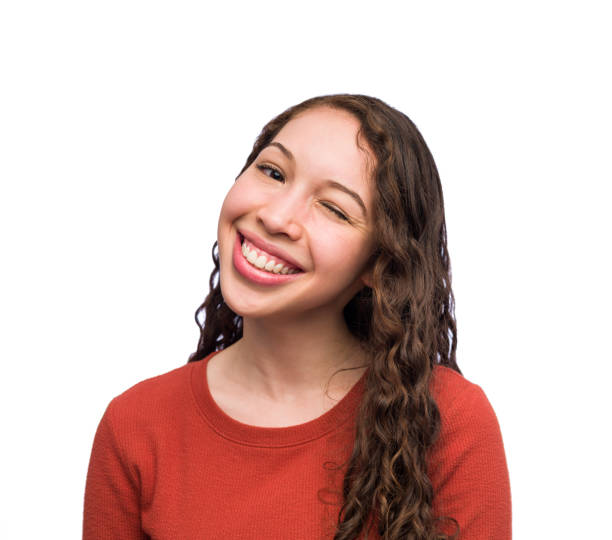 istock Friendly young woman winking at the camera 1168216539