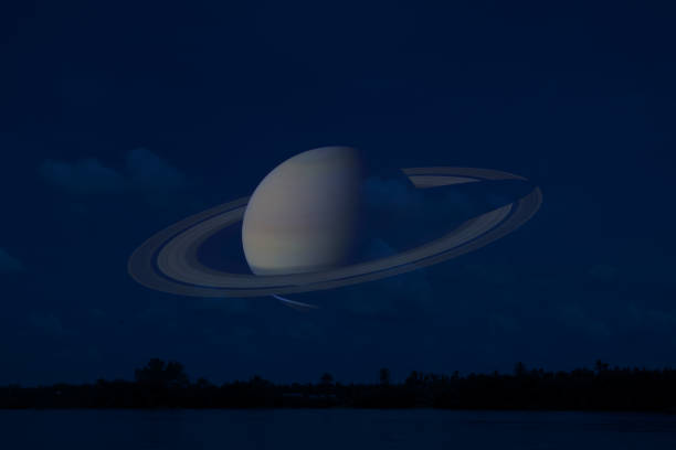 istock Saturn on night sky back silhouette mountain and river 1168216739