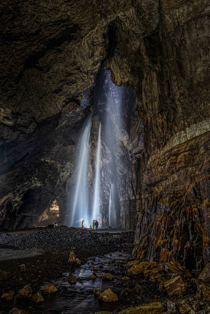 Underground waterfalls and river Inside Gaping Gill in Yorkshire one of the UK's largest underground chambers which is accessed through a pothole 98m (322ft) deep ingleborough stock pictures, royalty-free photos & images
