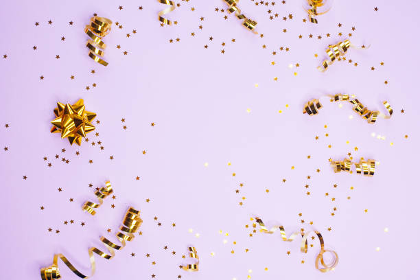 istock Golden decorations and sparkles on pale purple background 1168218546