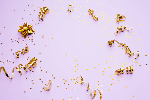 istock Golden decorations and sparkles on pale purple background 1168218635