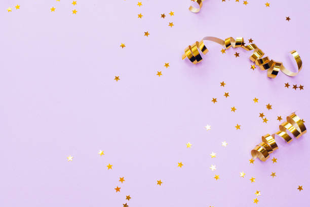 istock Golden decorations and sparkles on pale purple background 1168218644