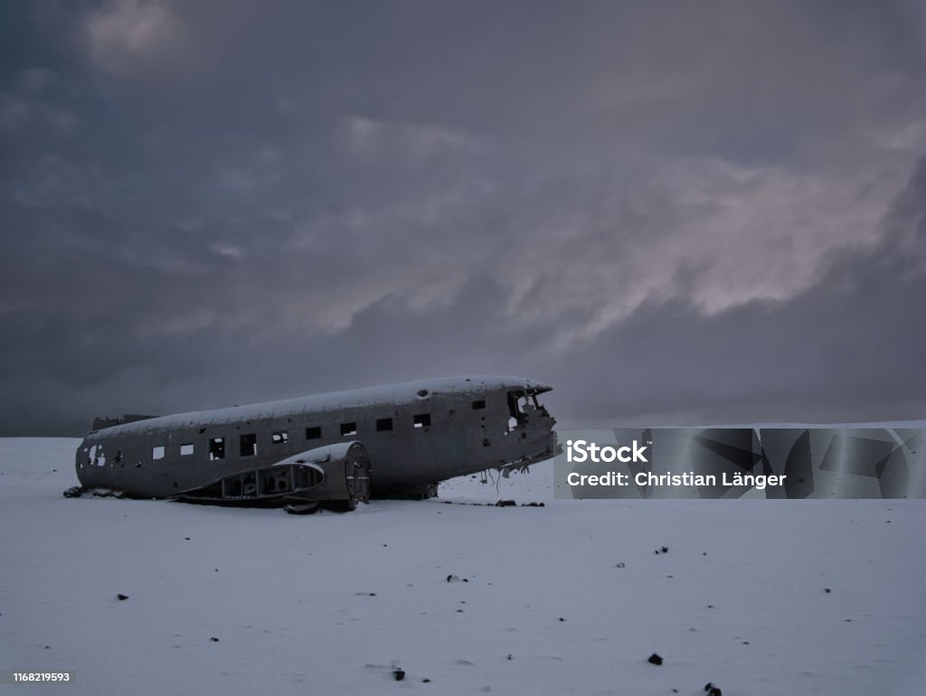 Crashed plane on a snowy field in iceland Crashed plane on a snowy field. Photo from March in Iceland Airplane Stock Photo