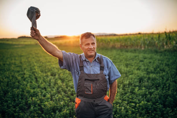 istock Senior farmer waving with cap 1168219903
