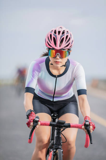 istock close up asian woman riding bicycle 1168221172