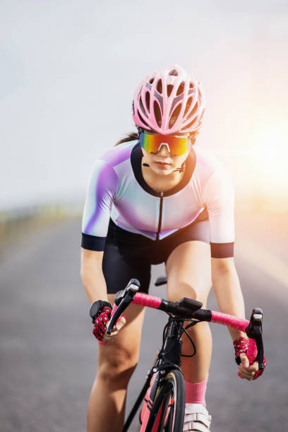 istock asian man riding bicycle on asphalt road against sunrise 1168221183