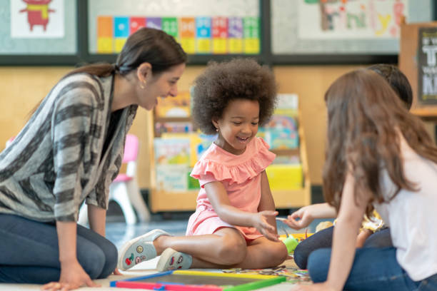 istock Preschool students playing in classroom with teacher 1168222917