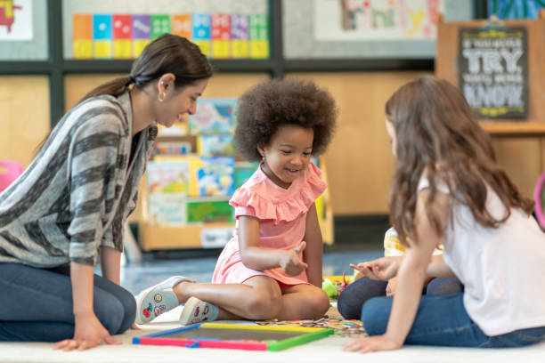 istock Preschool students playing in classroom with teacher 1168222920