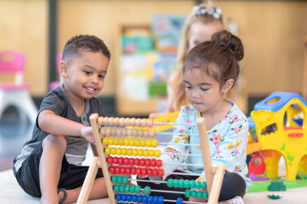 istock Multi-ethnic group of preschool students playing together in classroom 1168223031