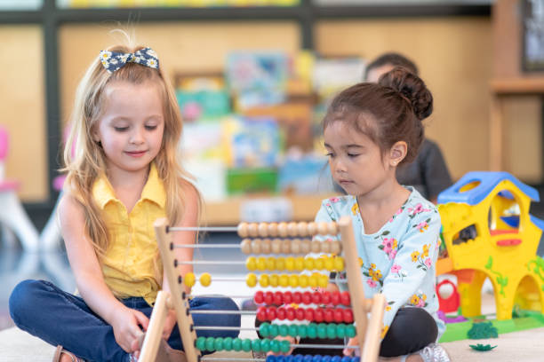 istock Cute preschool students playing together in classroom 1168223036
