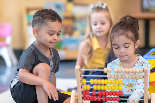 istock Multi-ethnic group of preschool students playing together in classroom 1168223185