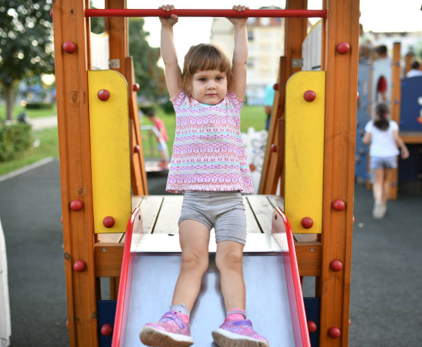 istock Two year old girl playing outdoors in summer 1168223930