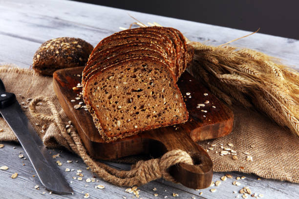 istock freshly baked bread on wooden board. cutted organic bread 1168224386