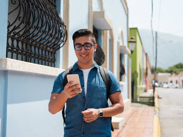 istock Cheerful young male looking at smartphone 1168225620