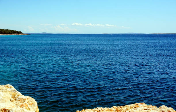 istock Blue wavy sea surface and horizon line, view from the rocky coast 1168231469