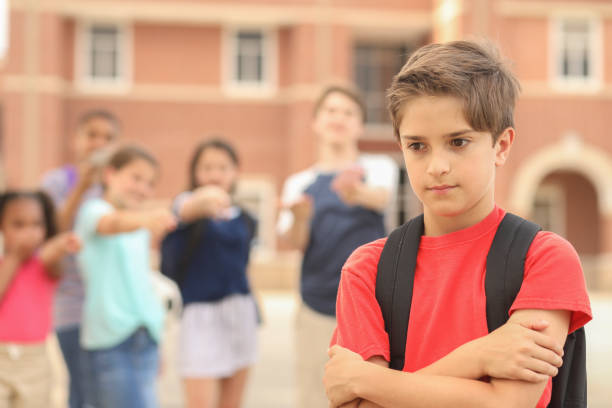 istock Elementary age boy being bullied at school. 1168234739