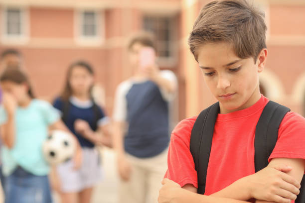 istock Elementary age boy being bullied at school. 1168234801