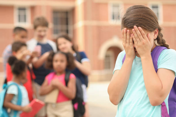 istock Elementary age girl being bullied at school. 1168234826