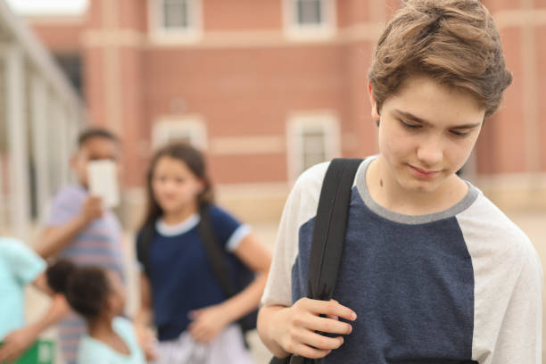 istock Junior high age boy being bullied at school. 1168236030