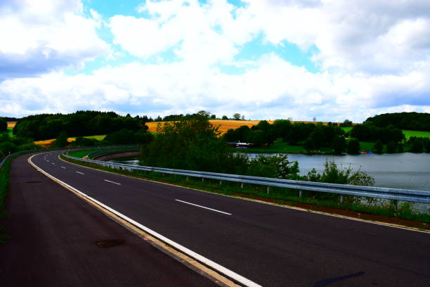 istock country road curve at lakeside 1168236036