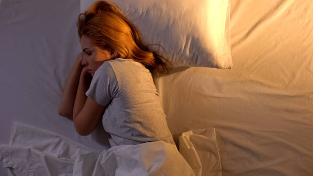 istock Caucasian sad woman feeling upset alone in bed at home, suffering depression 1168236143