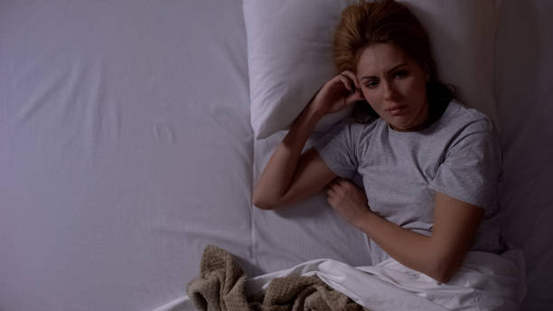 istock Sad lady awakening alone in bed at night, thinking about divorce, depression 1168236273