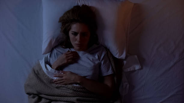 Annoyed woman suffering insomnia at night, uncomfortable sleeping conditions Annoyed woman suffering insomnia at night, uncomfortable sleeping conditions horror waking up bed women stock pictures, royalty-free photos & images
