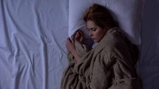istock Sad woman awakening at night and lying in bed, thinking about life problems 1168236591