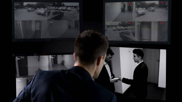 istock Security operator watching transfer of bribe on CCTV footage, safety concept 1168237245