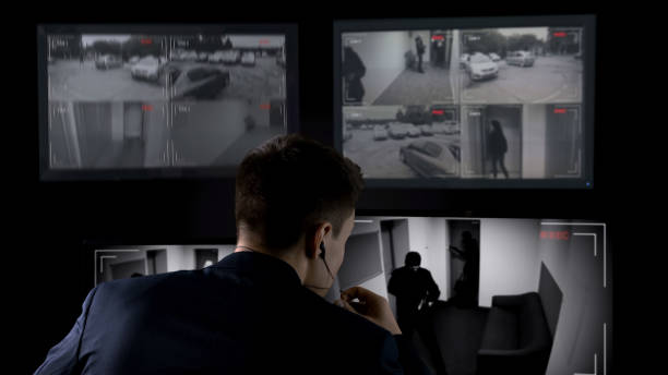 istock Security guard watching CCTV footage, calling police, thief break in building 1168237941