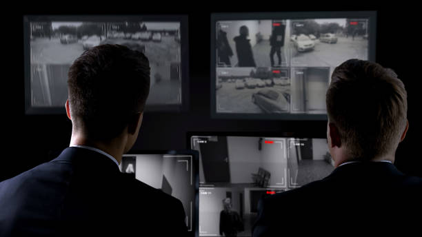 istock Security guards watching surveillance cameras, guarding important object, safety 1168237952