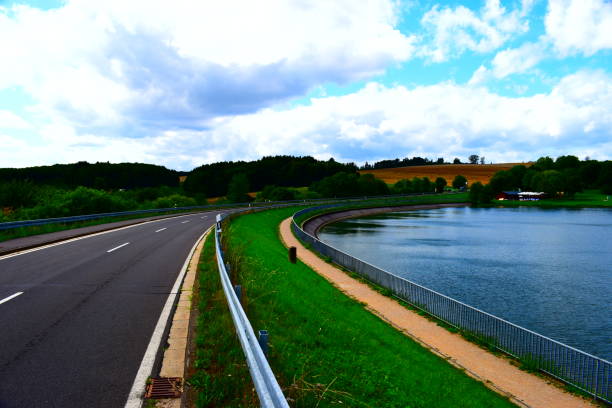 istock country road curve at lakeside 1168237964