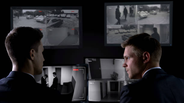 istock Security guards watching crime scene on surveillance cameras, espionage concept 1168238008