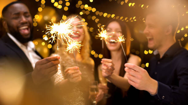 istock Overjoyed young people celebrating new year, holding bengal lights, having fun 1168238091