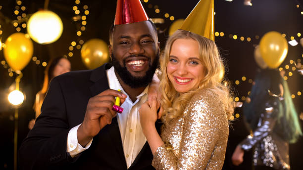 istock Smiling couple posing for camera in party hats, celebrating Christmas, fun 1168238111